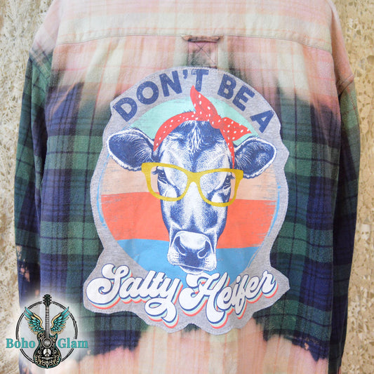 Back View: A Men's Large bleached plaid flannel shirt featuring a large back patch with a cow in glasses and the text "Don't Be A Salty Heifer."