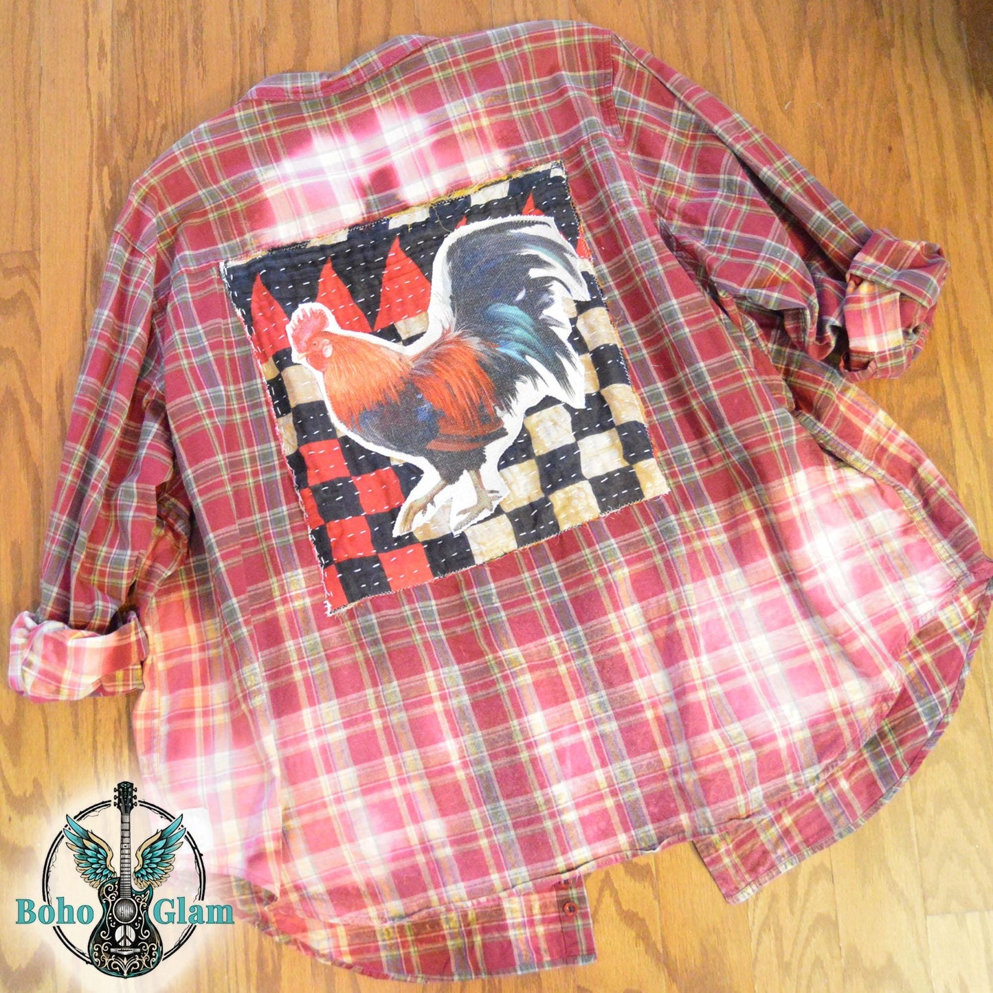 Back View Flat Lay: Rear view of the upcycled flannel laid flat highlighting the rooster patch and the transition from red plaid to bleached cream.