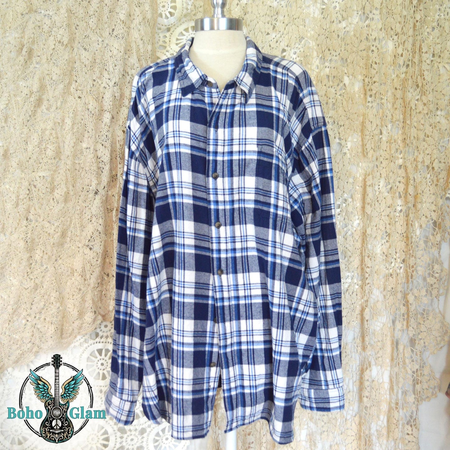 Front View on Mannequin: A long-sleeved blue plaid button-down shirt with a classic collar and double chest pockets.