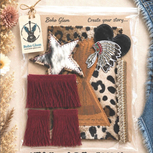 Boho Glam 'Wild Heart Tribe' craft kit (#005-W) containing various tribal-inspired fabric and leather accessories, including a star patch, feather patch, leopard print fabric, and red fringe tassels, displayed in a clear plastic bag on a neutral back