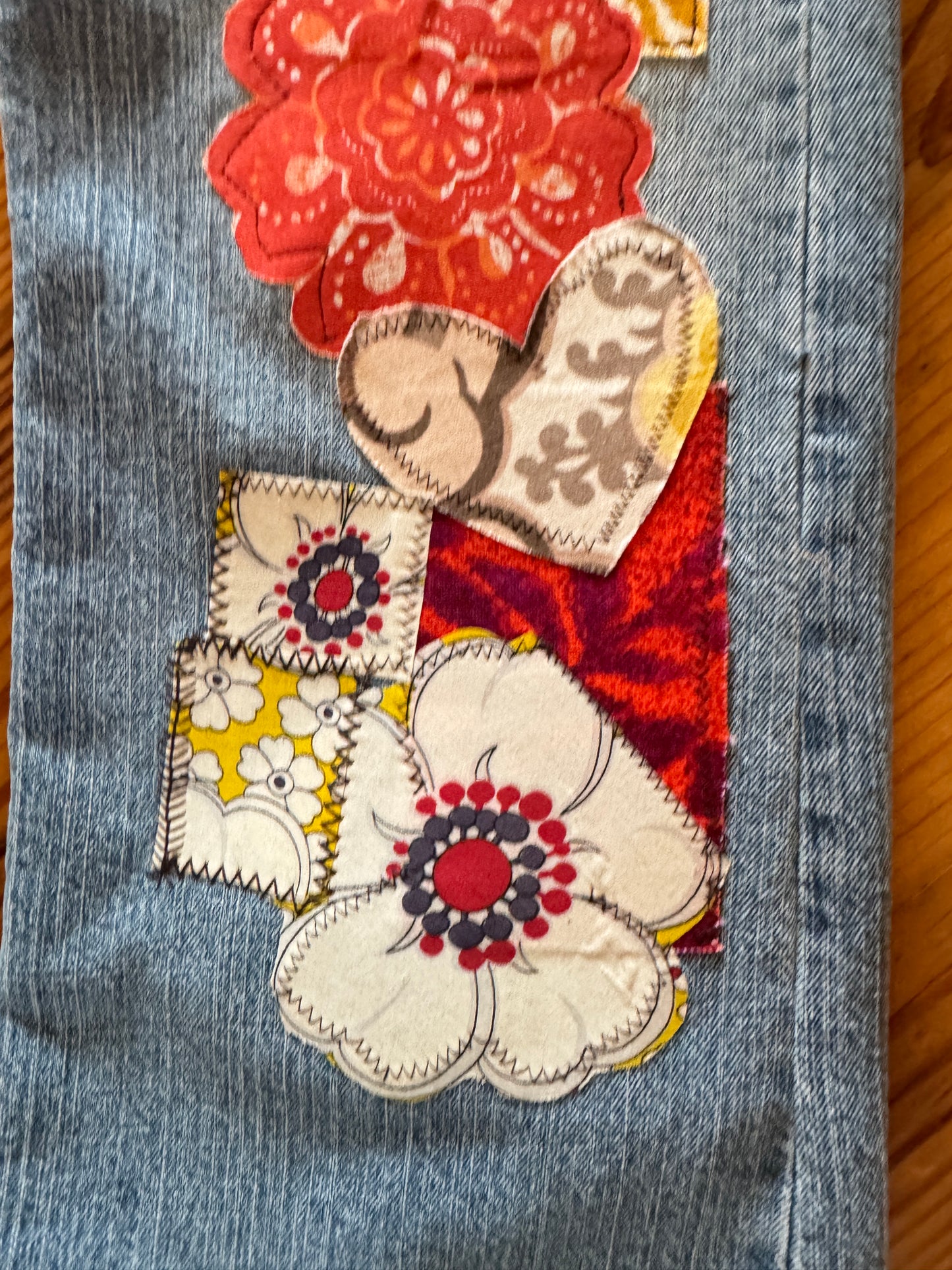 close up of vintage fabrics patched on ooak jeans